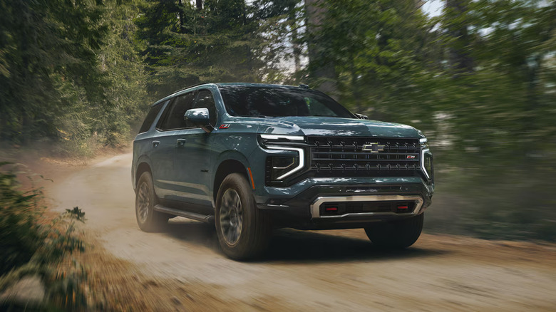 2025 Chevrolet Tahoe driving along a scenic highway