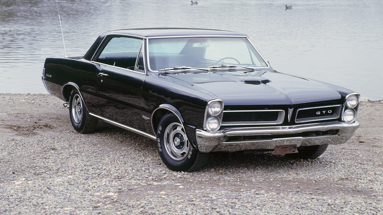 Black Pontiac GTO by water