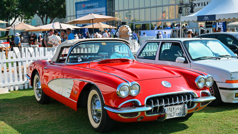 Red Corvette on green lawn