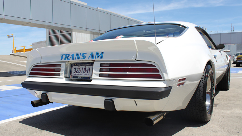 A rear three-quarter view of a stunning red 1974 Firebird, with the strip tailights in view.