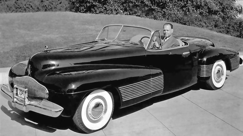 1938 Buick Y-Job concept seen from front left with designer Harley Earl behind the wheel