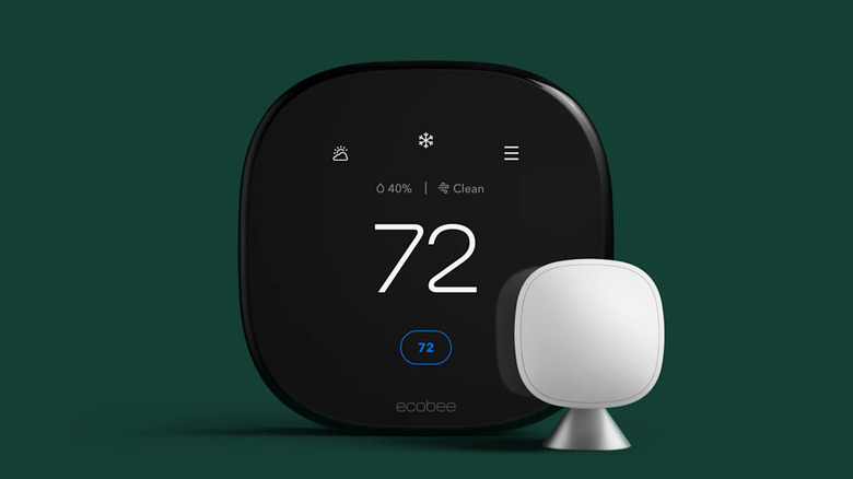An Ecobee Smart Thermostat Premium on a green backdrop