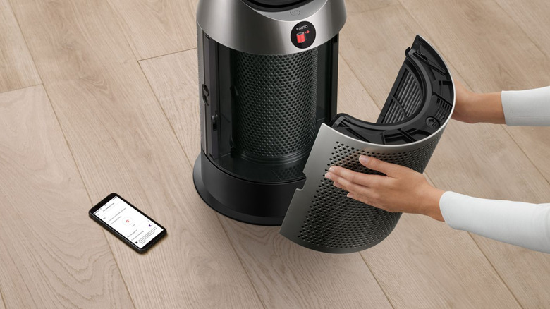 A person disassembling a Dyson humidifier