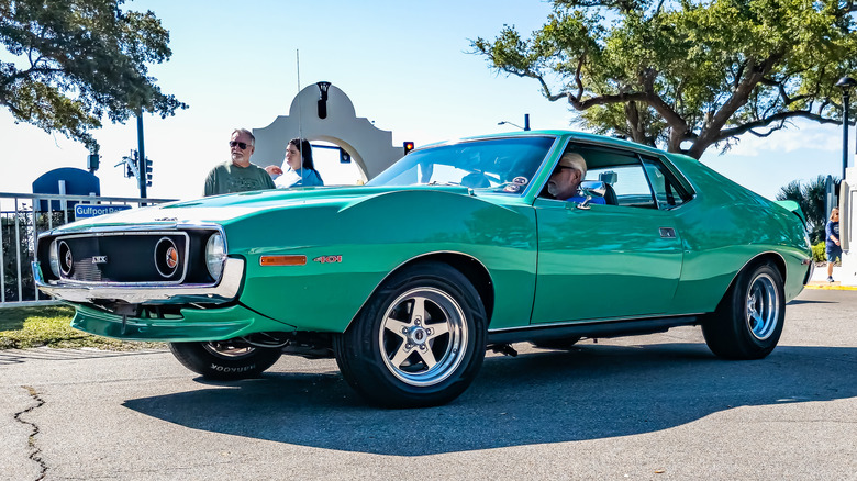 An AMC muscle car leaving an auto show