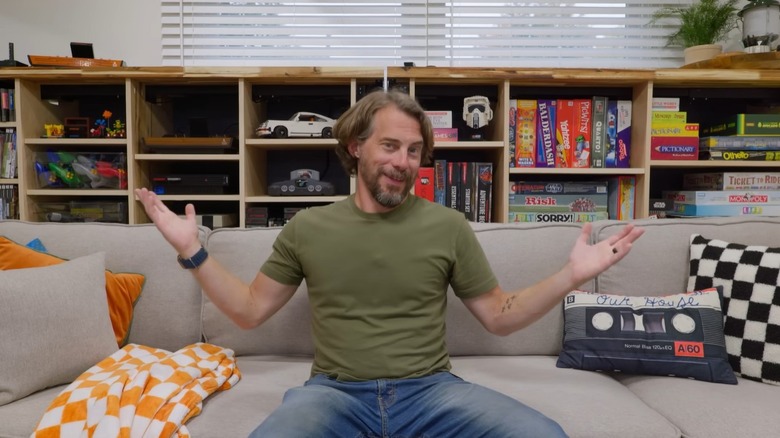 Bob from I Like to Make Stuff sitting in front of storage shelves