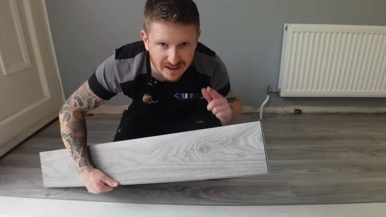 Cameron from The DIY Guy laying laminate flooring