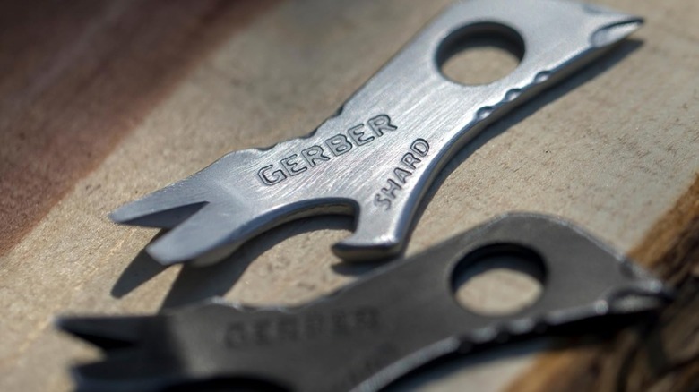 Two Gerber Shard keychains placed on a wooden surface
