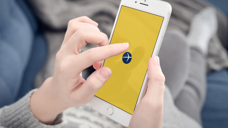 Woman using Expedia on her iPhone