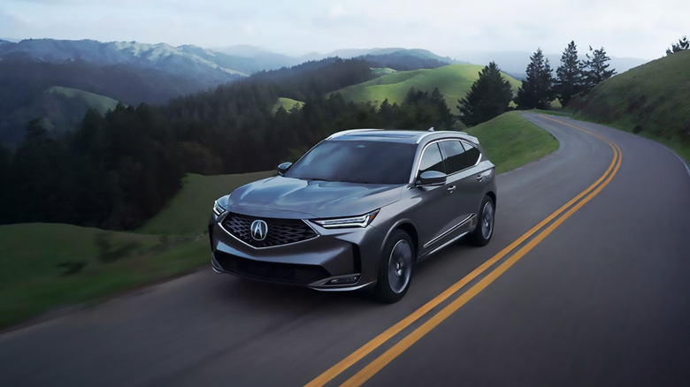 A gray Acura MDX driving on a mountainside