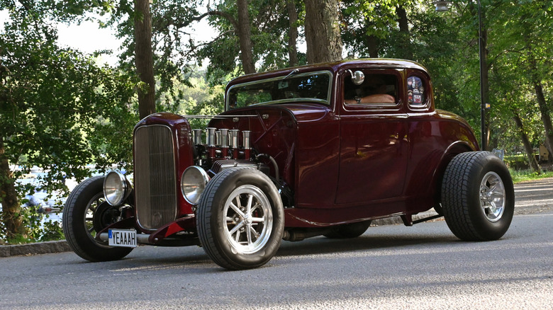 Maroon hot rod parked on pavement