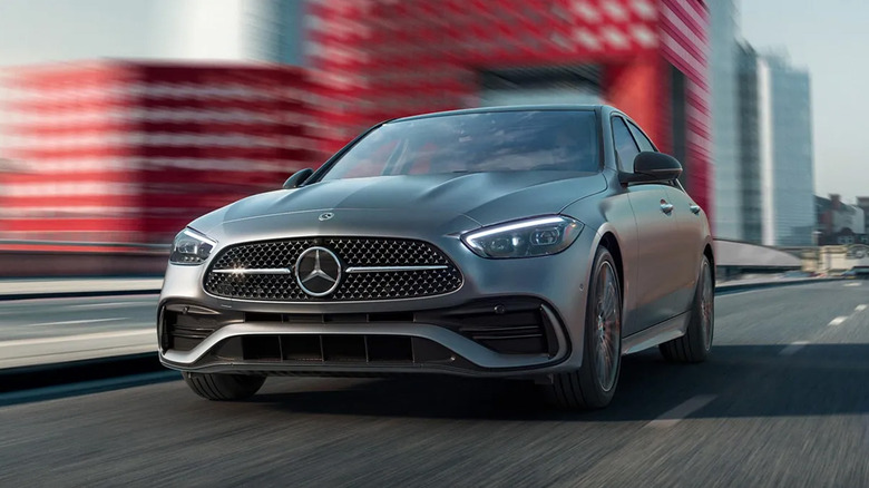 A dark gray Mercedes C Class car driving on a highway
