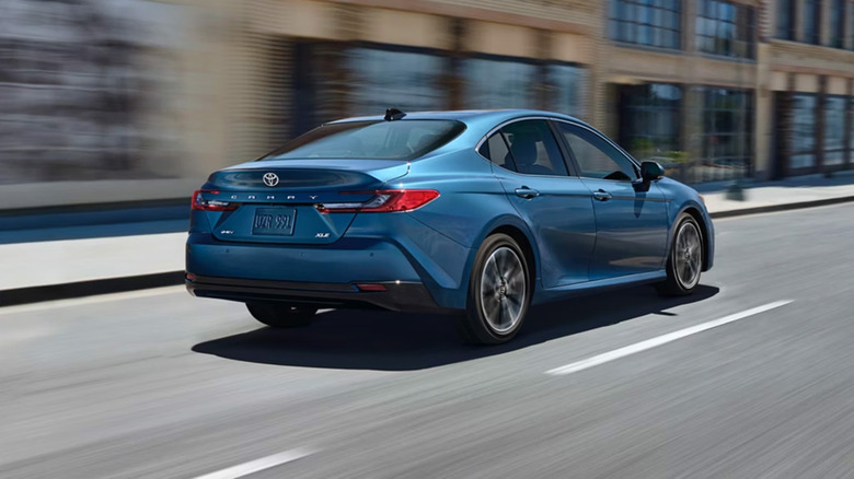 A blue Toyota Camry on a city street