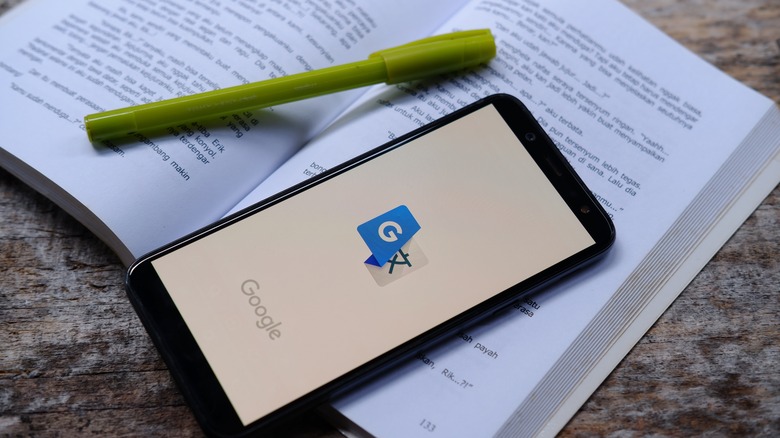 Google Translate app on smartphone on top of book