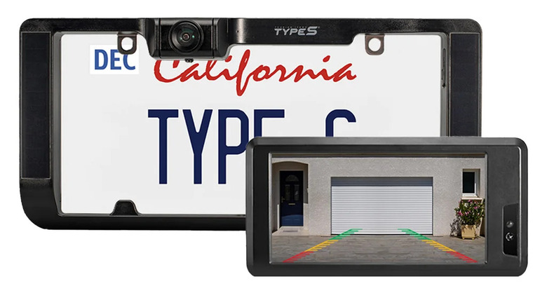 A license plate with an HD Solar-Powered Backup Camera frame.