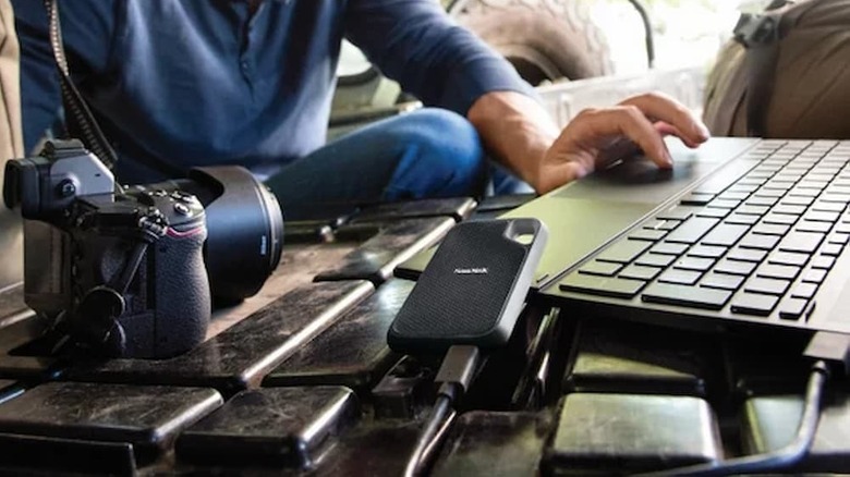 A SanDisk Extreme Go Portable SSD 1TB plugged into a laptop.
