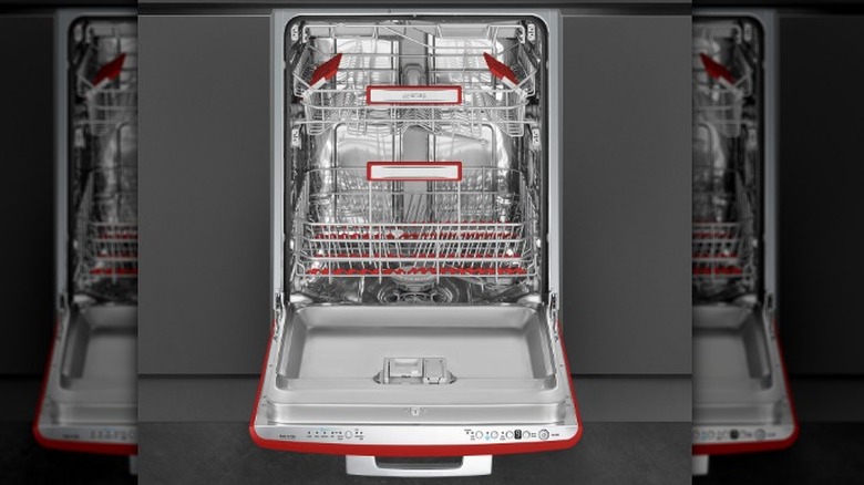 An open Smeg dishwasher showing off the interior