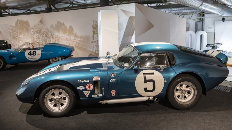 A blue 1964 Shelby Cobra Daytona Coupe in a museum