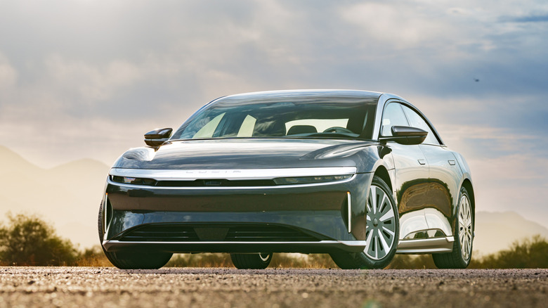 A dark gray Lucid Air in the desert