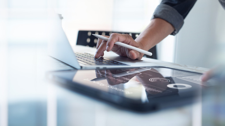 someone holding a stylus and tablet