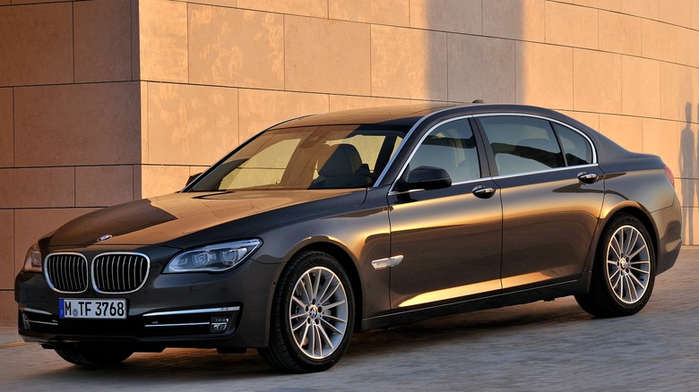 Black BMW 740Ld xDrive parked in front of a wall