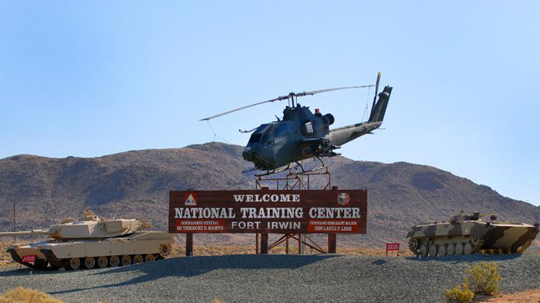 The welcome sign for Fort Irwin with a helicopter on it