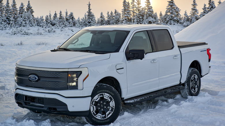 White Ford F-150 Lightning parked in snow