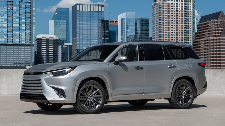 Silver Lexus TX 550h+ parked in a city