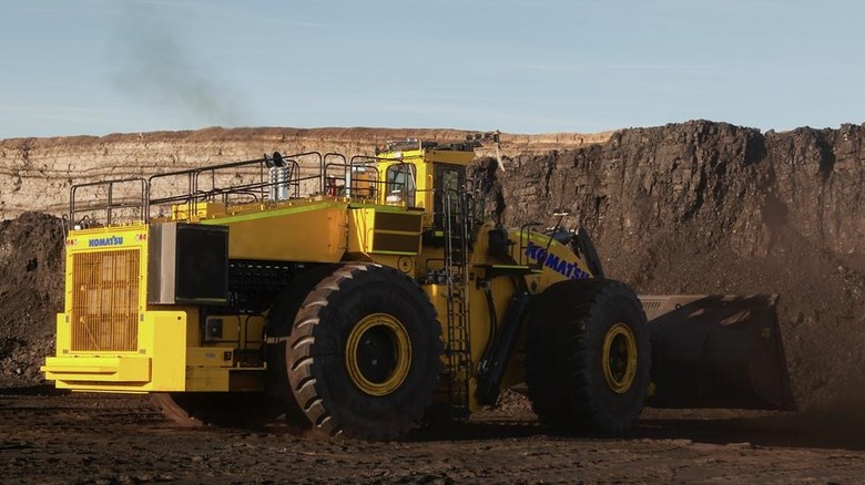 A bright yellow Komatsu WE2350 wheel loader (formerly the Letourneau L-2350) working at a mining site.