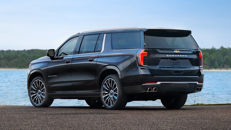 A black Chevrolet Suburban for the 2025 model year parked facing away from the camera.