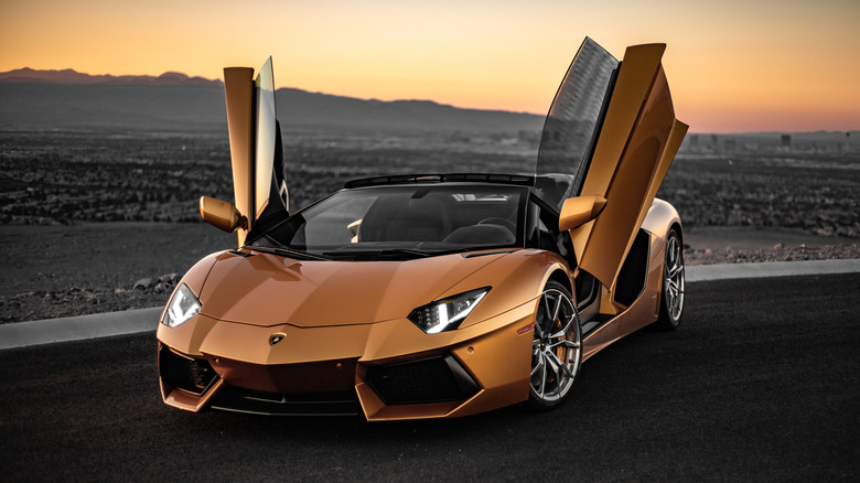 Gold Lamborghini Aventador at sunset