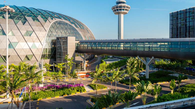 Glass dome exterior with a tunnel attached and greenery