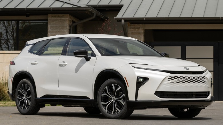 White Toyota Crown Signia parked in front of a building