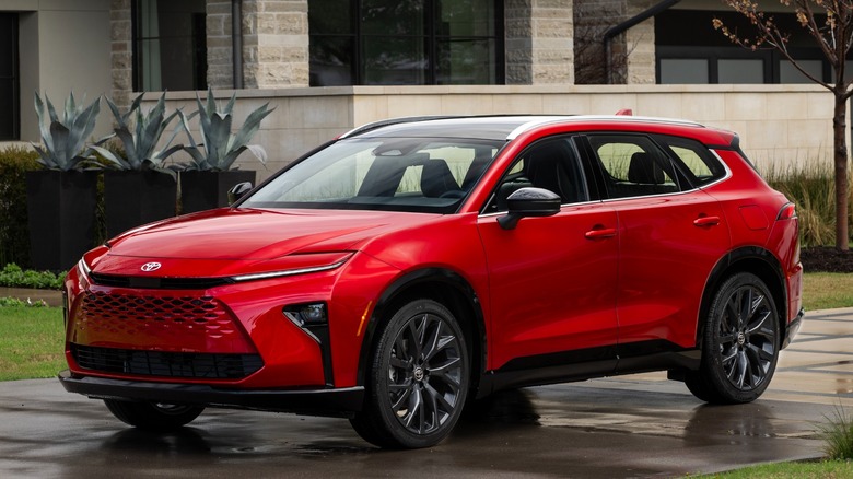 Red Toyota Crown Signia parked in front of a building
