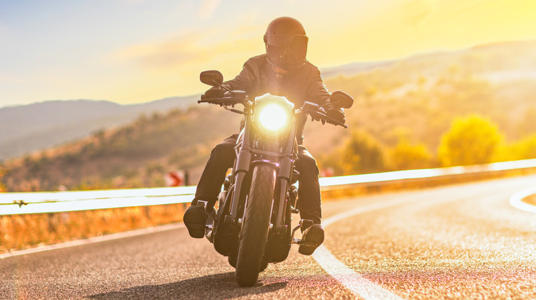 Man riding motorcycle at sunset