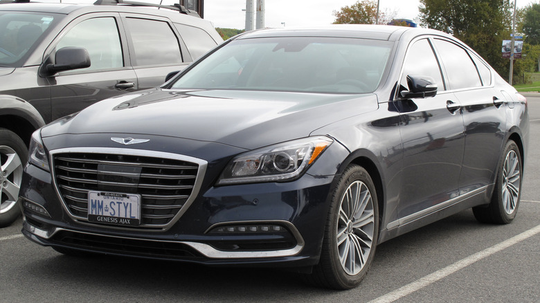 A dark blue 2018 Genesis G80 in a parking spot