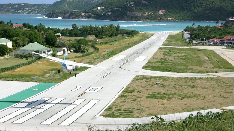 Small passenger plane landing on airstrip