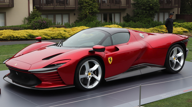 Red 2023 Ferrari Dayton SP3 seen from left front parked on display outdoors