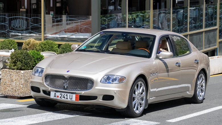 A fifth generation Maserati Quattroporte in gold, front 3/4 view
