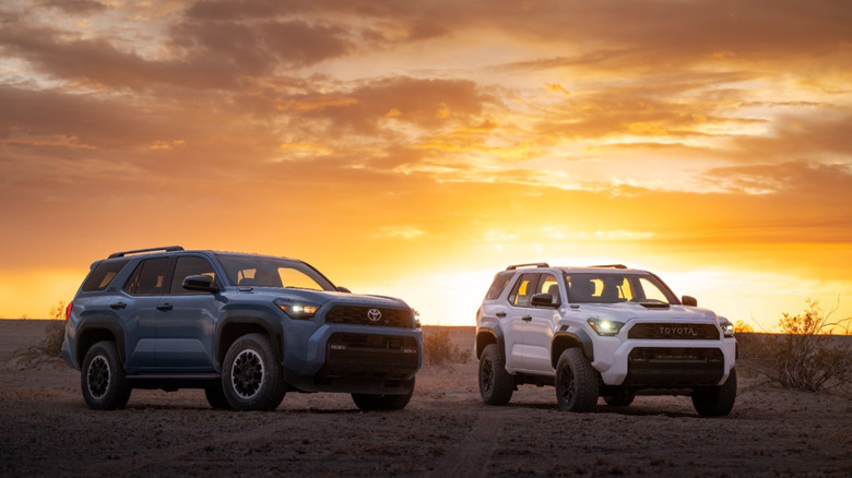 Two 2025 Toyota 4Runners in the evening, front three quarters view visible, against a setting sun and amber skies