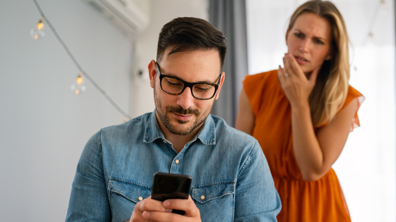 woman spying on partner's phone