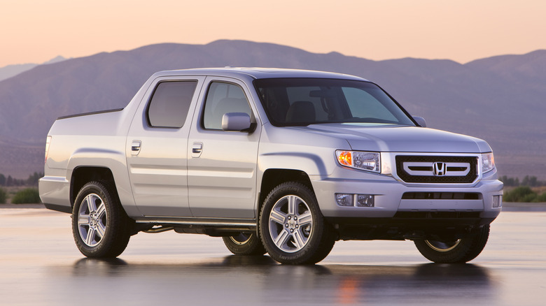 White 2010 Honda Ridgeline at sunset with mountains in background
