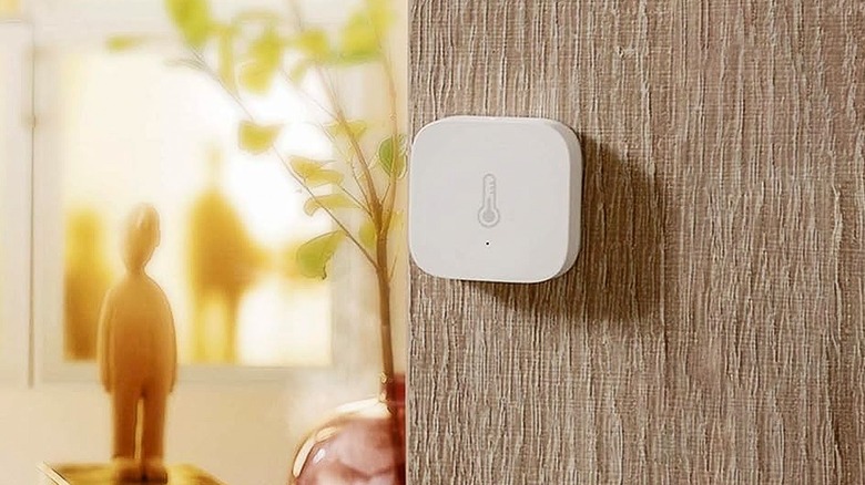 A temperature sensor mounted on a wall inside a home