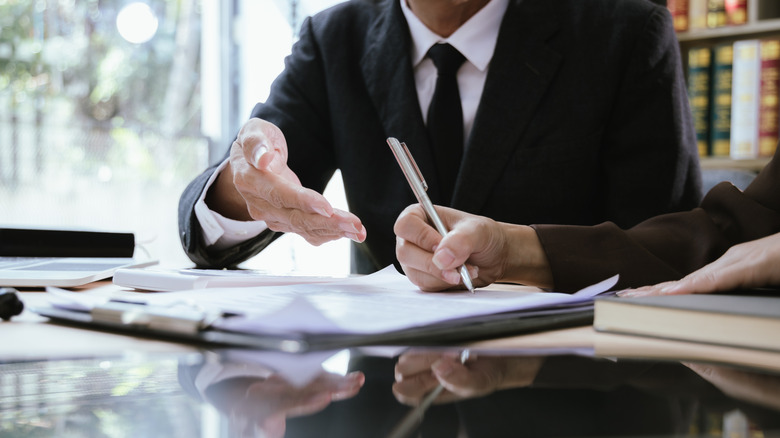 People signing documents