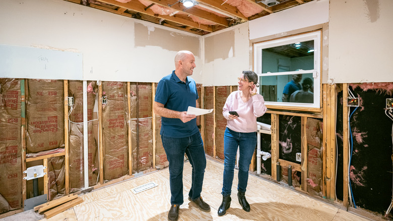 People standing inside half renovated home