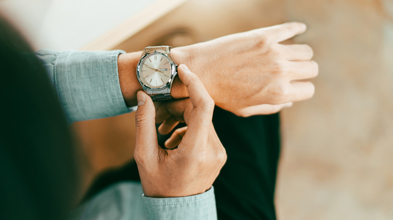 closeup of person looking at watch