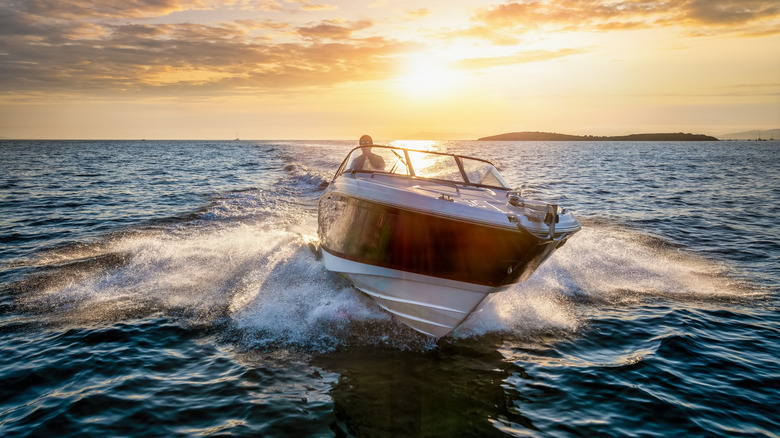 A man driving a boat in the sea