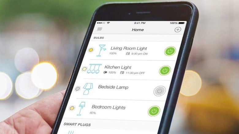 Hand holding a smartphone showing different light functions