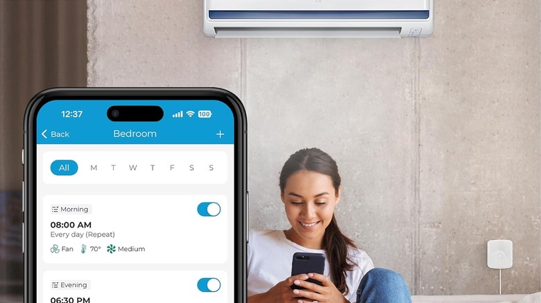woman using phone to control air conditioner