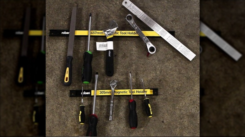 Different tools secured to the magentic bar