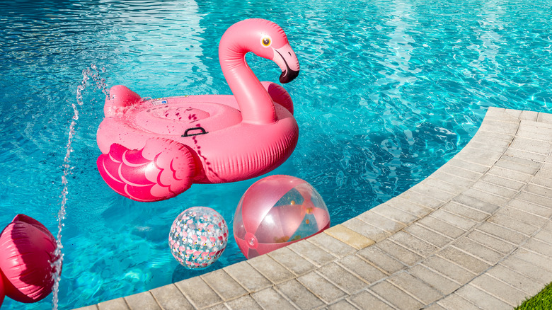 Pool with inflatable flamingo and various balls